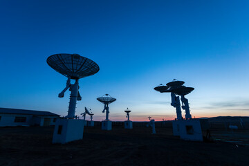 The silhouette of a radio telescope