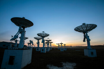 The silhouette of a radio telescope