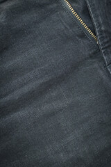 black denim clothing texture background, front of pants fashion with zip