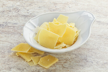 Sliced parmesan cheese heap in the bowl