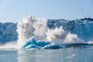 Dramatic ice calving from the Monacobreen Glacier in Liefde Fjord, small tidal wave and icebergs...
