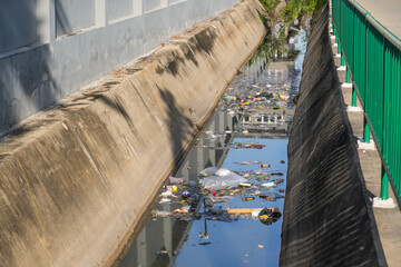 City canals for water drainage - plastic bottles, bags, packaging, dirty ditch, water pollution,...