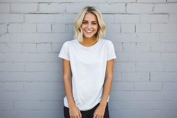 Portrait of a smiling young woman standing against a white brick wall - obrazy, fototapety, plakaty