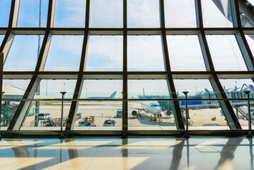 Airport terminal glass window with view of airplane, airport interoir departure hall for travel and...