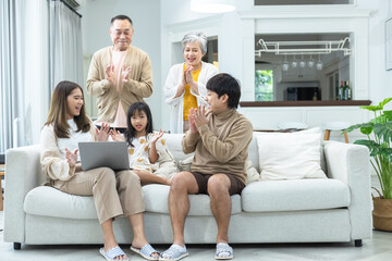 Happy big family Grandfather Grandmother mother father and Granddaughter having fun living room at...