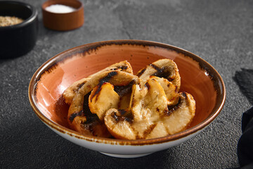 Perfectly grilled champignon mushrooms served in a terracotta bowl, a delicious and earthy addition to any meal