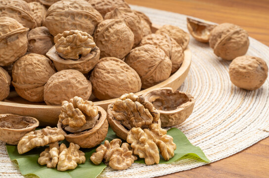 Walnuts in wooden tral on wooden background, Walnuts kernels on wooden table.