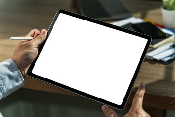 A businessman holds a mockup. iPad digital tablet with blank screen Mockup replaces your design mockup in the office. - Powered by Adobe