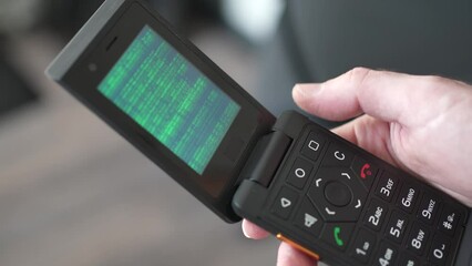 Hacked Vintage Flip Phone With Green Coding Animation on Screen