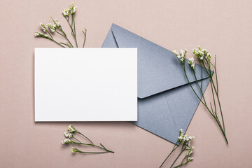 Gray envelope with flowers on a brown background. Postcard, layout.