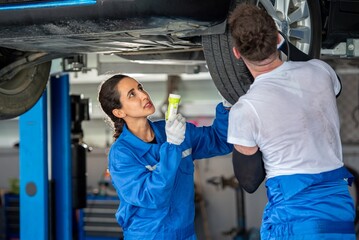 Obraz premium auto two professional mechanical technician garage motor car engine team check automobile engine for diagnostic maintain transmission machine. technician worker auto in garage check engine car motor