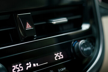 close-up of car dashboard, hazard flasher switch or emergency light button in modern car, shallow...