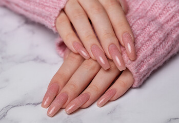 Obraz na płótnie Canvas Female hands with pink nail design