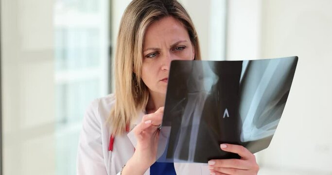Traumatologist radiologist analyzes x-ray of patient ulnar bones