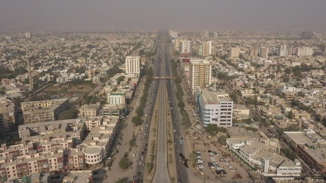 Drone footage of cars driving on Shahrah-e-Sher Shah Suri on a sunny day in Sindh, Pakistan