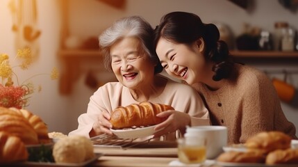 Elderly mother cooks with her daughter in the kitchen