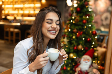 Young beautiful stylish woman with cup of coffee sitting in restaurant, Beautiful cute woman in the cafe with coffee smiling