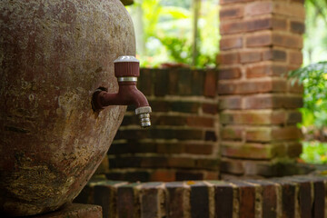 close up of Antique bronze water faucet on a jug stand installed outdoors - drinking water, washing...