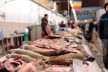 A Fisherman's Bounty: A Man Standing by a Table Overflowing with Fresh Catch from Obor Fisher Market