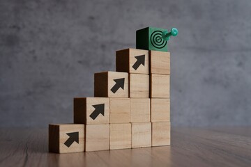 Wooden blocks with arrow and target board. Copy space for text. Business goals, objective and...