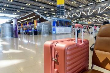 Close up of airplane passenger baggage at airport terminal hall.
