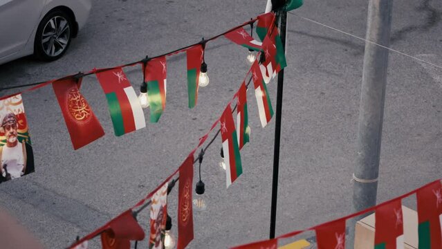 Oman flags fluttering proudly in the wind. National pride, patriotism and dynamic visuals. Perfect for cultural events, national celebrations, and patriotic representations.