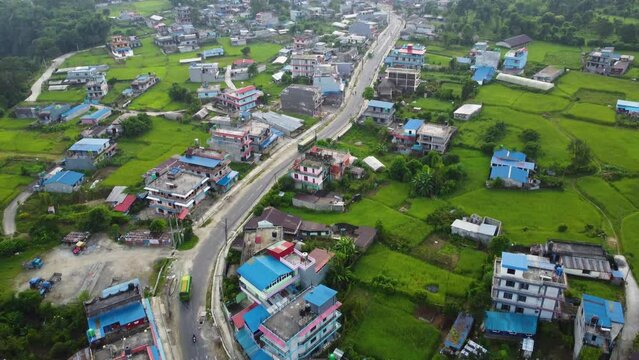 Aerial tilt Up shot showing Pokhara City of with main road and old buildings with blue colored roofs in Nepal