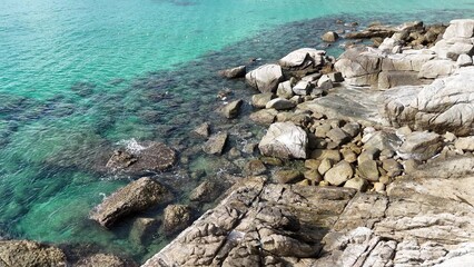 Tranquil scene of turquoise waters of the sea and rocky shore