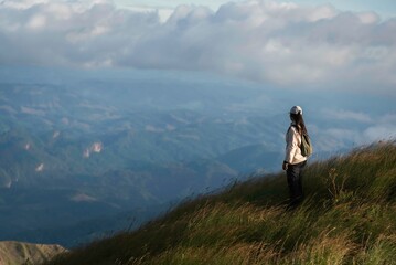 Hiker asian woman happy feeling freedom good and strong weight victorious facing on the natural mountain. Travel Concept