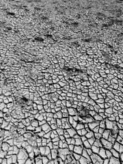 Top view black and white dry and cracked ground.Global warming effect.earth cracked effect of salt water.