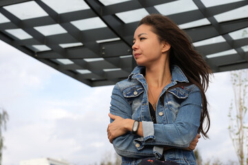 Beautiful young woman wearing jeans jacket enjoying outdoors