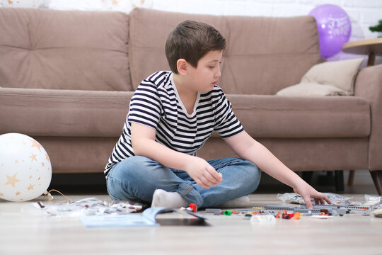 little cute boy playing lego toys at home.