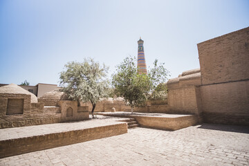Ancient minaret Islam Khoja Minaret on a sunny summer day in the ancient city of Khiva in Khorezm