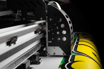 view of Closeup of Large Inkjet printer in working with multi color cmyk colors in containers on...