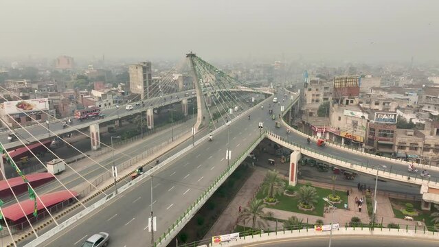 Aerial drone shot over traffic movement along Azadi bridge in Pakistan during morning time.
