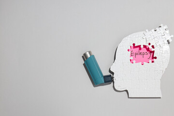 Epilepsy day concept, human paper head with inhaler