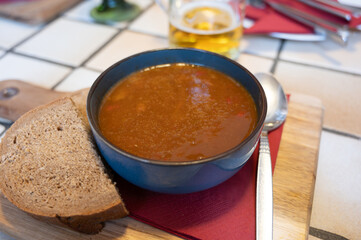 German food, thick, rich goulash meat soup served hot in bowl in old German cafe in countryside