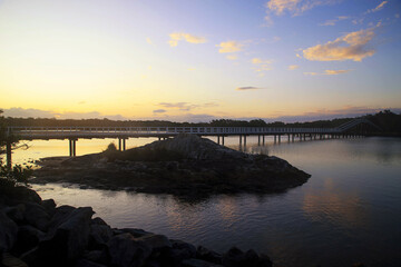 Sunset at Back creek bridge South west rocks,Australia. Beautiful sunset  and sky clouds at the Back creek Bridge, South west rocks, Australia/ Reflective sunset at Back creek bridge South west rocks.