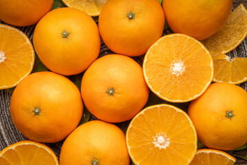 Fresh Orange fruit in wooden basket on wooden background.
