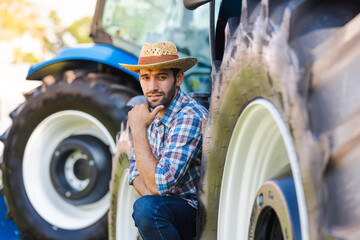 Farmer sitting with tractor and looking at camera