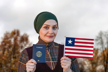 Muslim Woman Holding Passport and Flag of Liberia
