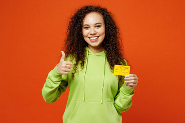 Young smiling woman of African American ethnicity she wear green hoody casual clothes hold in hand...