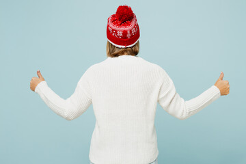 Back rear view merry elderly woman 50s years old wearing sweater red hat posing show thumb up like...