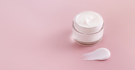 cream jar cosmetic smear cream texture on pastel pink background