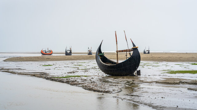 Scenic seascape panorama of beautiful traditional wooden fishing boats known as moon boats on Inani beach, Cox's Bazar, Bangladesh