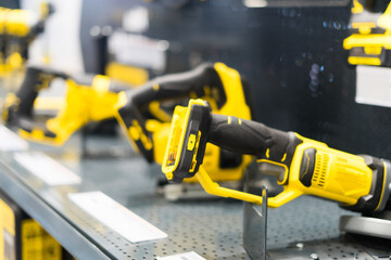 Power tools, drills and hammers of various manufacturers are sold in a hardware store.