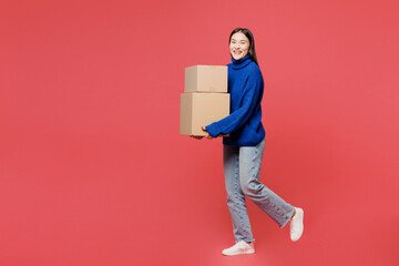 Full body young happy woman of Asian ethnicity she wearing blue sweater casual clothes hold...