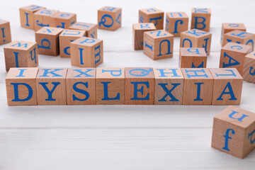 Cubes with word Dyslexia on white wooden table
