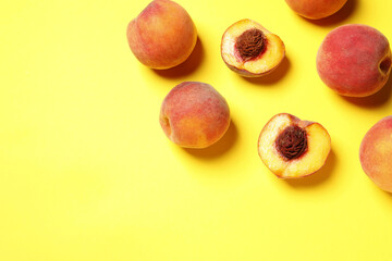 Delicious juicy peaches on yellow background, flat lay. Space for text