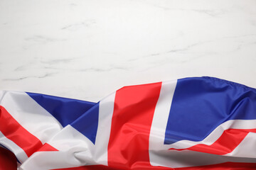 Flag of United Kingdom on white marble background, top view. Space for text